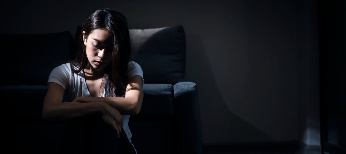 adult sitting alone feeling emotionally numb and disconnected